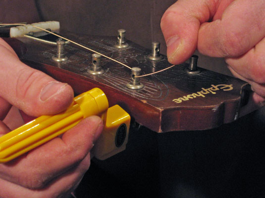 tuning pegs guitar. wind the tuning peg