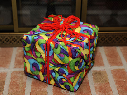 Leftover fabric and extra yarn create green gift wrap!