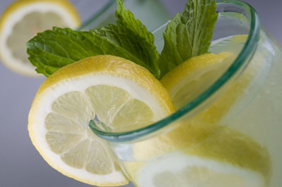Citrus wedges and fresh mint sprigs adorn this beverage. [Credit: Focal length: 55mm, Shutter speed