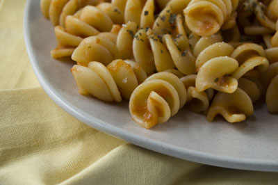 A folded napkin creates warmth under a pasta dish. [Credit: Focal length: 48mm, Shutter speed: 1/10
