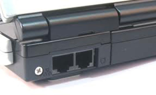 A network jack (left) and modem jack (right) on the back of a laptop computer.