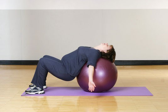 An oversized plastic ball is a nifty flexibility gadget, perfect for exercising during pregnancy. [
